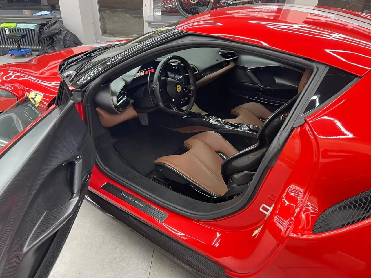 Ferrari 296 GTB 2023, front view — Milan Luxury Cars, Milan. The Ferrari 296 GTB pairs a V6 hybrid powertrain with 830 hp, a combination that gives it…