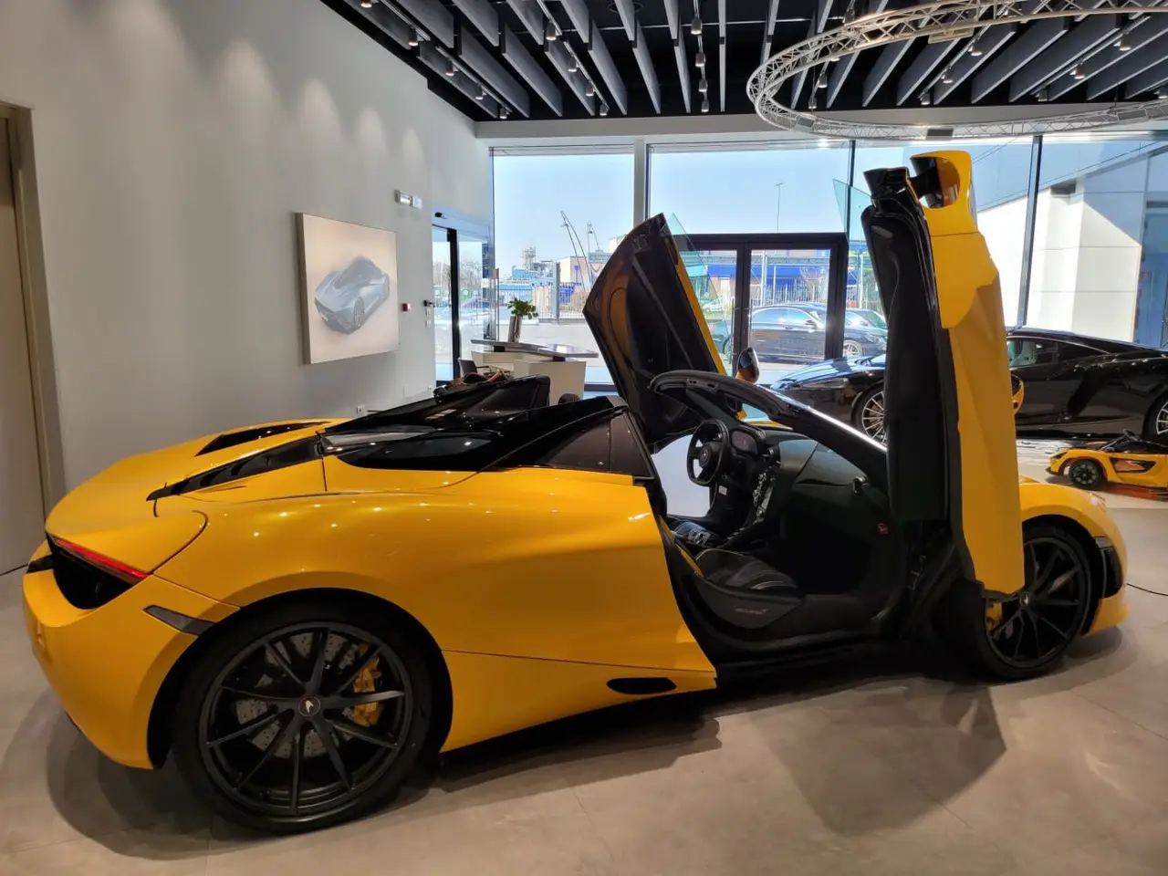 McLaren 720S Spider 2022, front view — Milan Luxury Cars, Milan. The 2022 McLaren 720S Spider pairs a 720 hp V8 with a folding hard top, giving two…