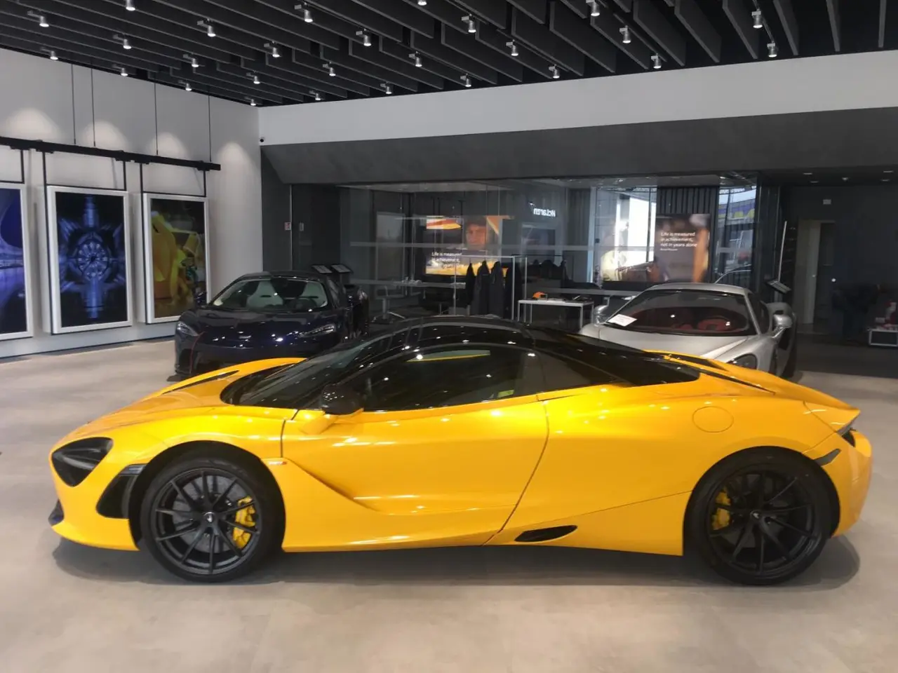 McLaren 720S Spider 2022, rear view — Milan Luxury Cars, Milan. The 2022 McLaren 720S Spider pairs a 720 hp V8 with a folding hard top, giving two…