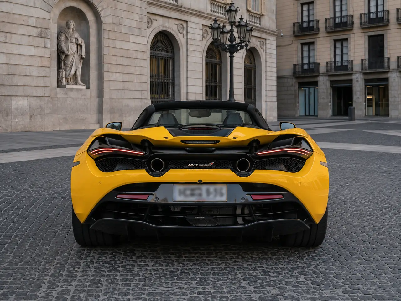 McLaren 720S Spider 2022, rear view — Milan Luxury Cars, Milan. The 2022 McLaren 720S Spider pairs a 720 hp V8 with a folding hard top, giving two…